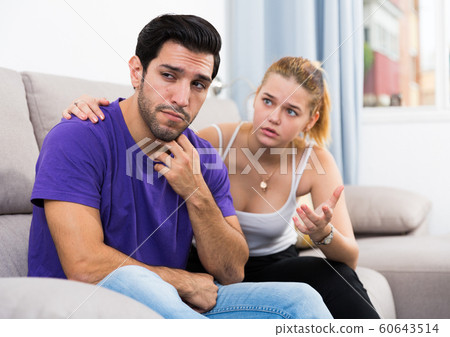 Girlfriend soothing upset man 60643514