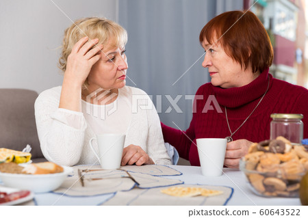 Mature lady comforting upset female Mature lady comforting upset female 60643522