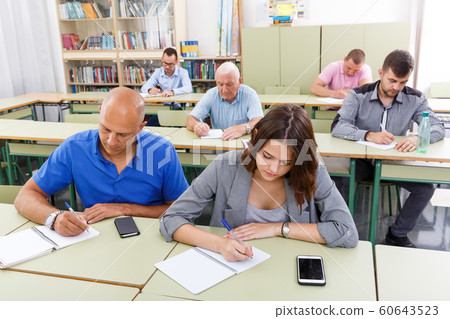 Men and women take a written exam Men and women take a written exam 60643523