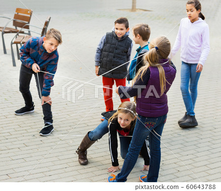 Children games. Girl goes through the tangled rope Children games. Girl goes through the tangled rope 60643788