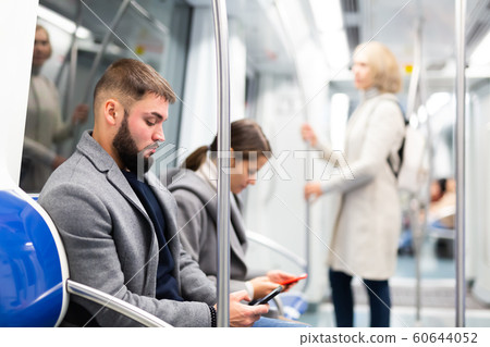 People browsing in smartphone in subway People browsing in smartphone in subway 60644052