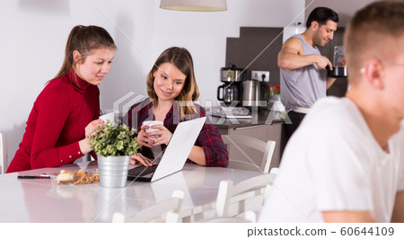 Two girls at kitchen of hostel 60644109