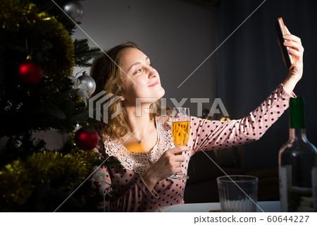 Young woman is posing for selfie in New Year night Young woman is posing for selfie in New Year night 60644227