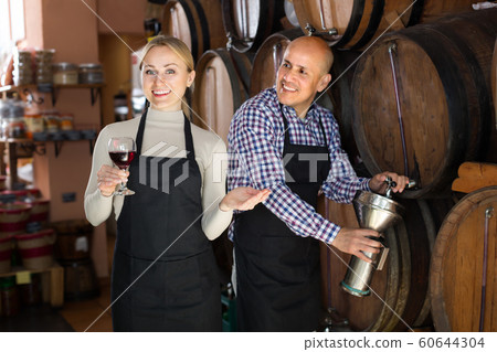 Portrait of two cheerful wine makers taking wine Portrait of two cheerful wine makers taking wine 60644304