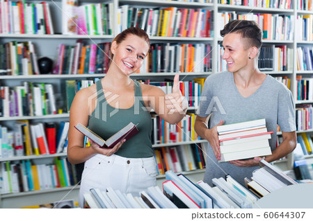 Glad girl and boy teenagers showing thumbs up Glad girl and boy teenagers showing thumbs up 60644307