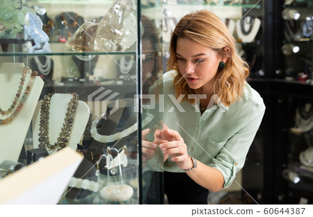 Woman choosing natural stone beads 60644387