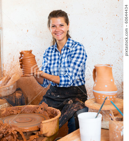 Girl sitting behind pottery wheel Girl sitting behind pottery wheel 60644434