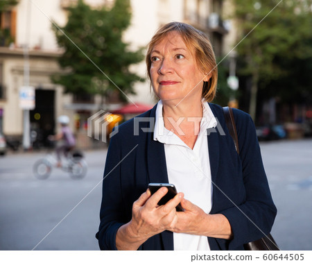 Senior woman using her smartphone Senior woman using her smartphone 60644505