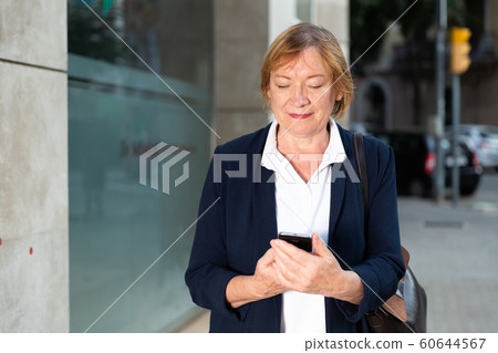 Elderly woman using mobile phone Elderly woman using mobile phone 60644567