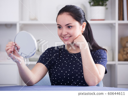 Cheerful gir looking in mirror Cheerful gir looking in mirror 60644611