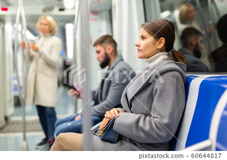 Pretty woman in public land transport 60644817