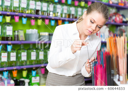 Woman looking for incense sticks Woman looking for incense sticks 60644833