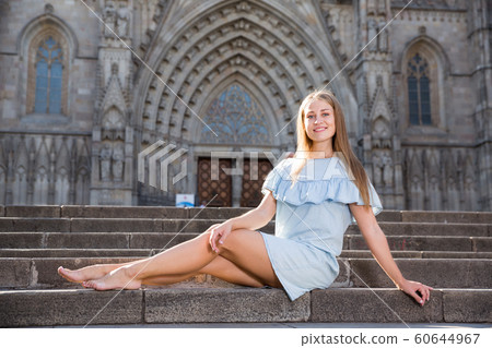 Girl sitting on stairs of temple 60644967