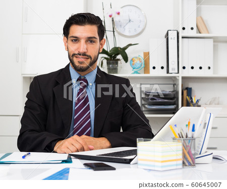 Portrait of smiling businessman who is productive working 60645007