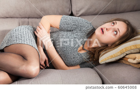 Unhappy woman having stomachache 60645008