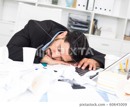 Spanish man is sleeping at desk after productive day Spanish man is sleeping at desk after productive day 60645009