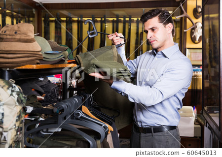 Man buying hunt clothes Man buying hunt clothes 60645013
