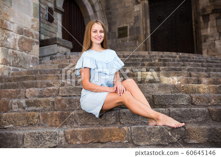 Girl sitting on stairs of temple Girl sitting on stairs of temple 60645146