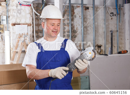 Contractor using angle grinder Contractor using angle grinder 60645156