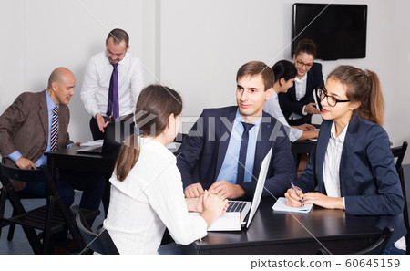 People working productively on business project together People working productively on business project together 60645159