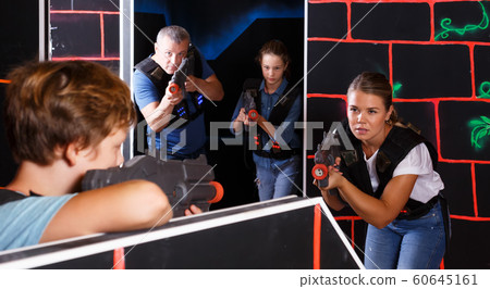 Kids and adults playing lasertag 60645161