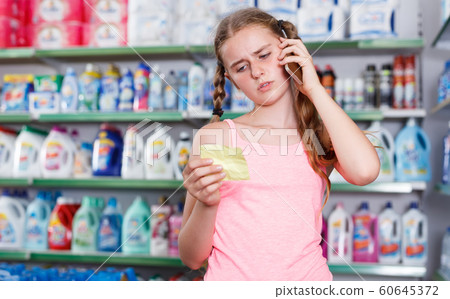 girl with shopping list speaking on mobile girl with shopping list speaking on mobile 60645372