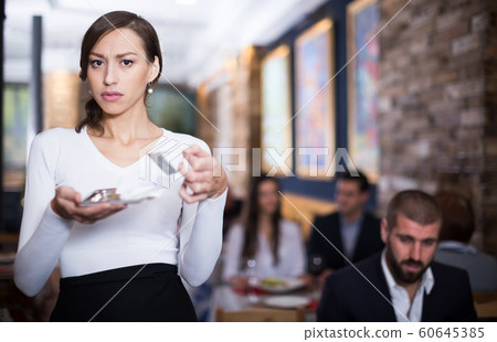 waitress girl holding a tray with money 60645385