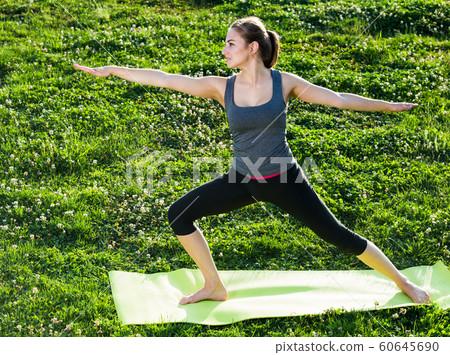 girl exercising on mat in morning outdoor girl exercising on mat in morning outdoor 60645690