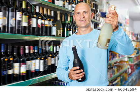 Portrait of adult customer selecting wine Portrait of adult customer selecting wine 60645694
