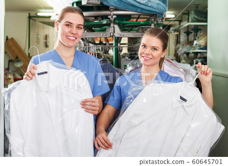Two workers showing clean clothing 60645701