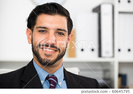Young male is happy at work place Young male is happy at work place 60645795
