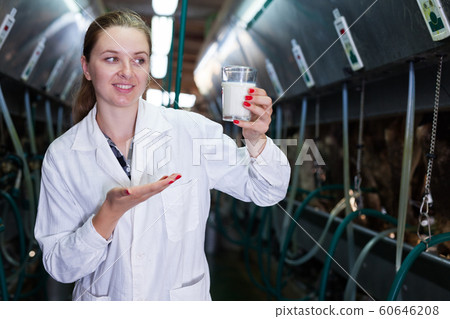 Dairy engineer with glass of milk Dairy engineer with glass of milk 60646208