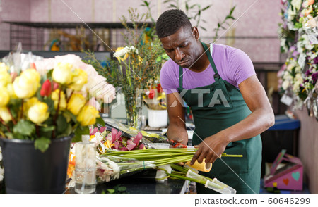 Man creating floral arrangement with gerberas Man creating floral arrangement with gerberas 60646299