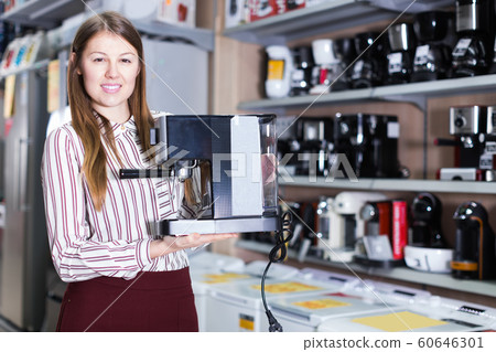 saleswoman offering coffee machine saleswoman offering coffee machine 60646301