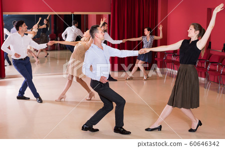 Young group people dancing lindy hop in pairs 60646342