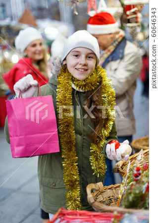 Teenage girl with Christmas balls 60646343