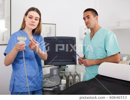 Elderly man doctor and young assistant Elderly man doctor and young assistant 60646553