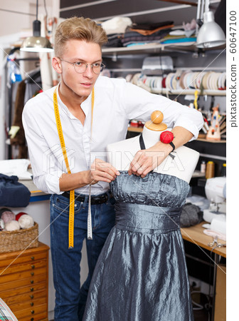 Dressmaker using tape measure Dressmaker using tape measure 60647100