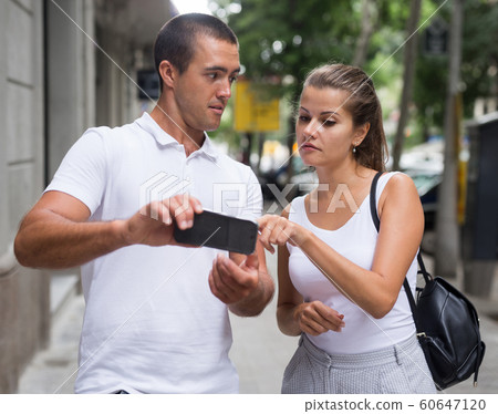 Couple using smartphone for orientation in city Couple using smartphone for orientation in city 60647120