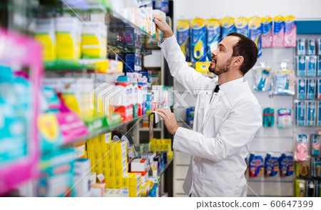 Male pharmacist looking for right medicine Male pharmacist looking for right medicine 60647399
