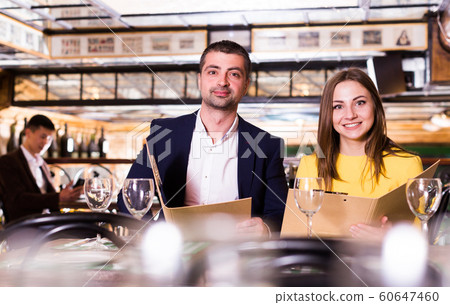 Female and male are looking in menu for order dinner Female and male are looking in menu for order dinner 60647460