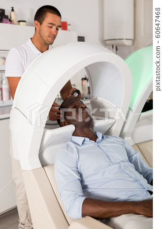 African American male leaning heads on sink African American male leaning heads on sink 60647468
