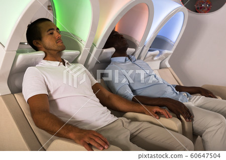 Male clients sitting in armchairs for washing hair 60647504