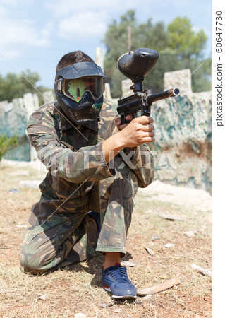 Man playing paintball Man playing paintball 60647730