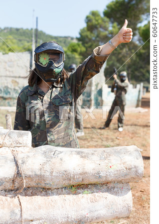 Female paintball player in mask with paint Female paintball player in mask with paint 60647733