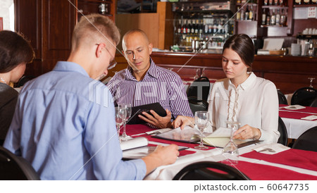 Friends choosing meal from menu 60647735