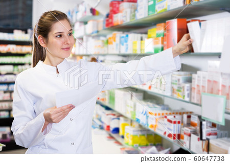 Woman pharmacist working in pharmacy Woman pharmacist working in pharmacy 60647738