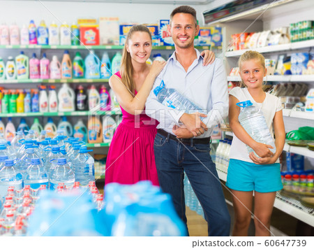 Young family with kid are choosing water in bottles Young family with kid are choosing water in bottles 60647739