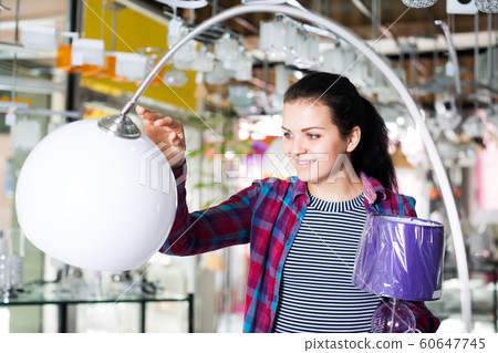 Girl admires an unusual lamp 60647745