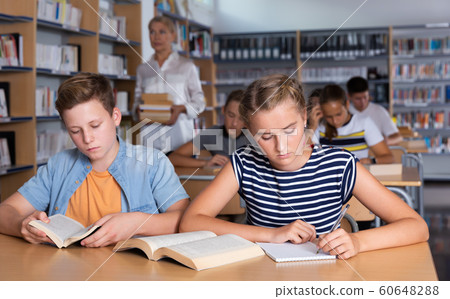Modern teenage schoolers reading and writing Modern teenage schoolers reading and writing 60648288